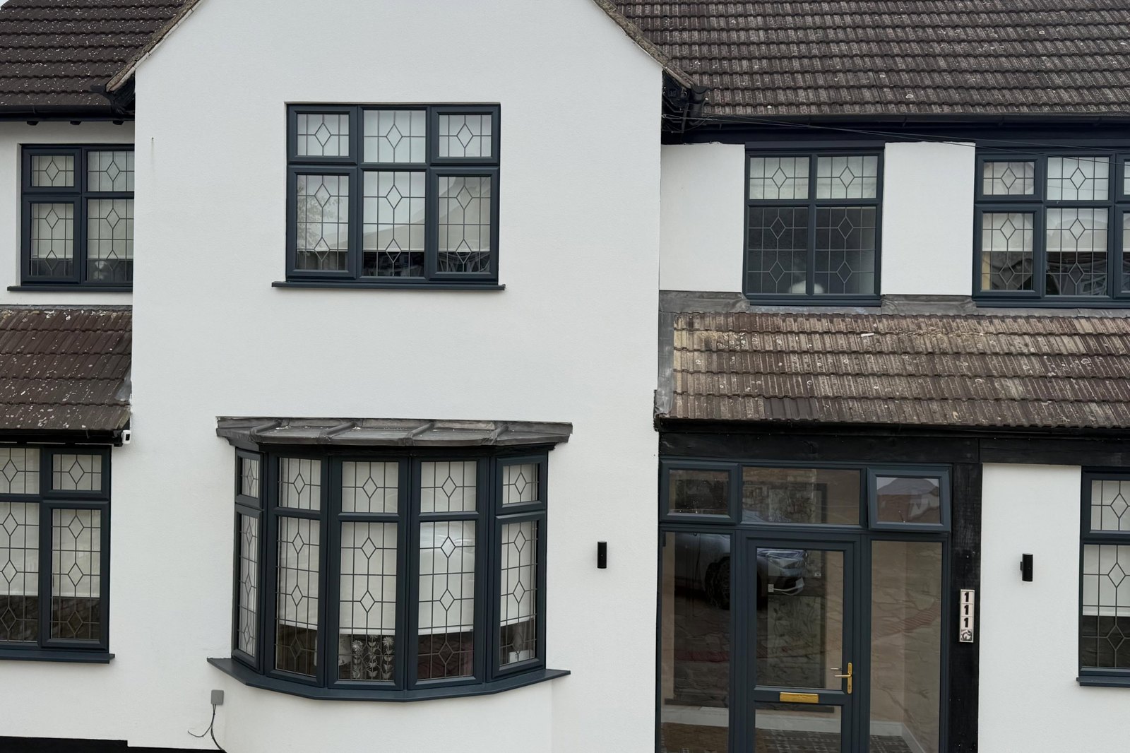 House front after new silicone render, resprayed windows and rebuilt walls