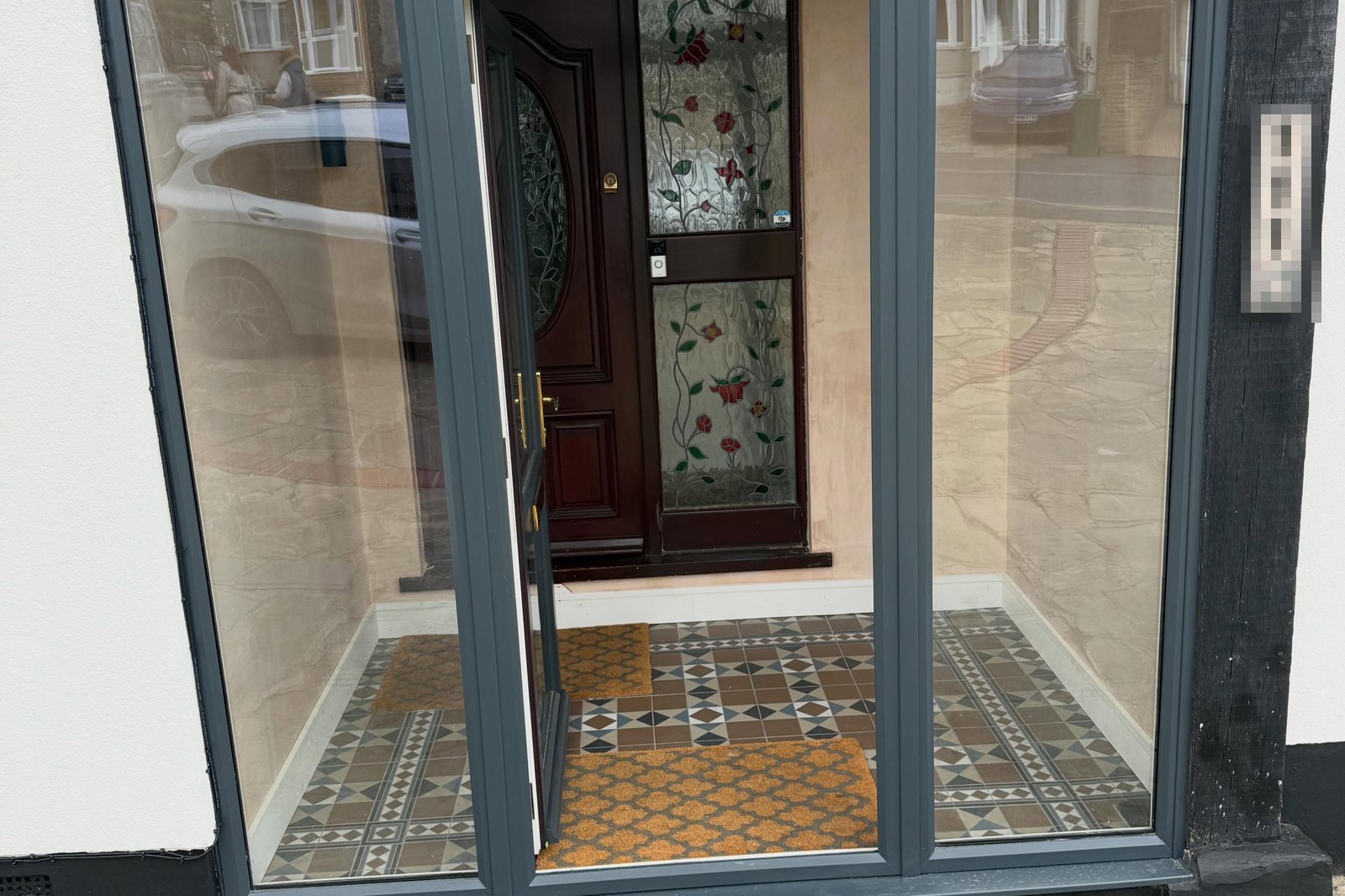 Renovated porch with encaustic floor tiles and a new glazed surround